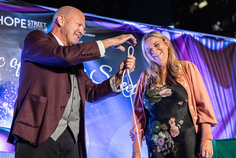 Magician Markey Furey conducting a magic trick with a guest